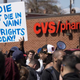 Demonstrators hold up a placard near the CVS Pharmacy on Pennsylvania Avenue in Baltimore that was looted and burned April 28, 2015.
JIM WATSON/AFP/Getty Images